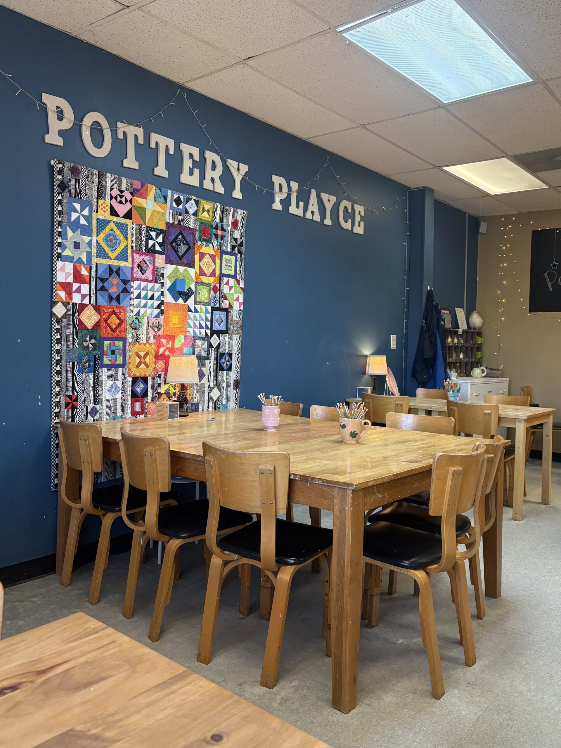 A large table for paint your own pottery is shown