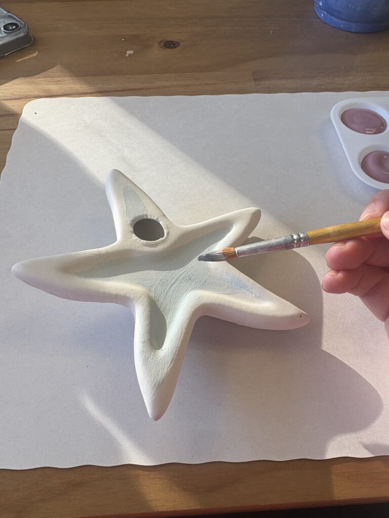 The starfish piece is flipped upside down and partially painted a light blue