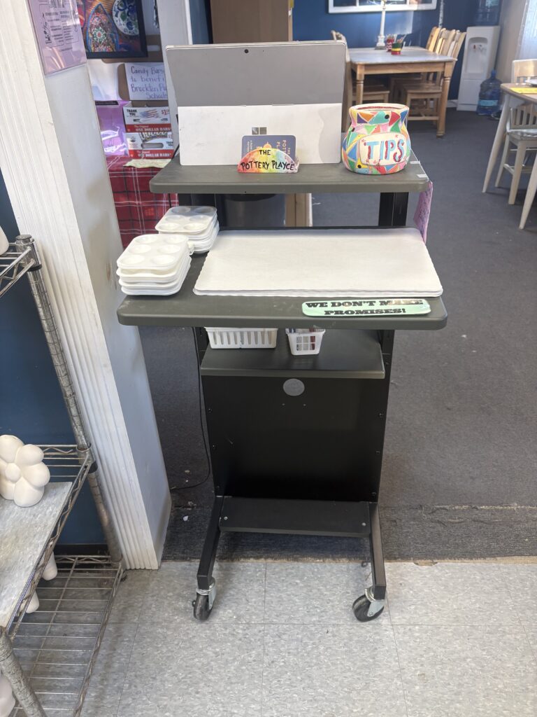 A small check in stand where you check in for to the paint your own pottery studio