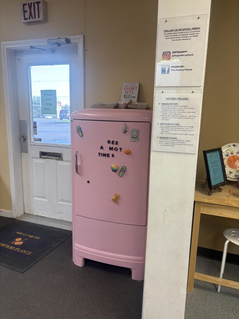 A light pink vintage fridge (from likely the 60s or 70s) is shown