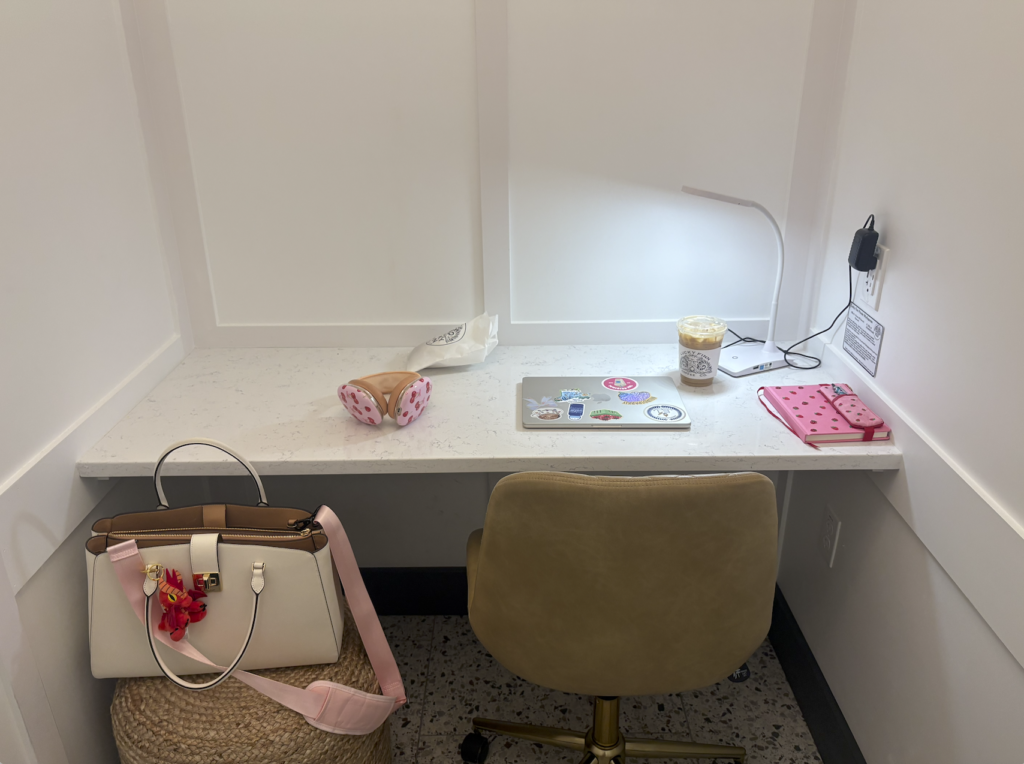 The office set up at Lucky Finn Cafe includes a desk, chair, stool, desk lamp and outlet 