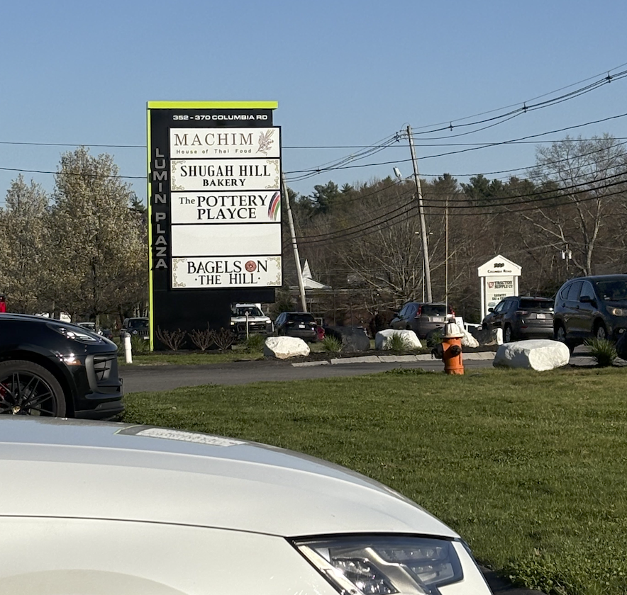 The black and green sign road sign for the pottery playce is shown
