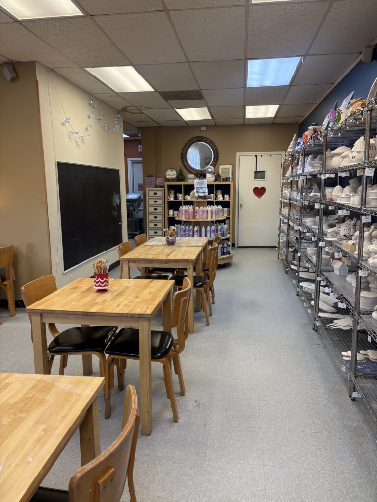 The aisle next to the selection of paint your own pottery pieces is shown
