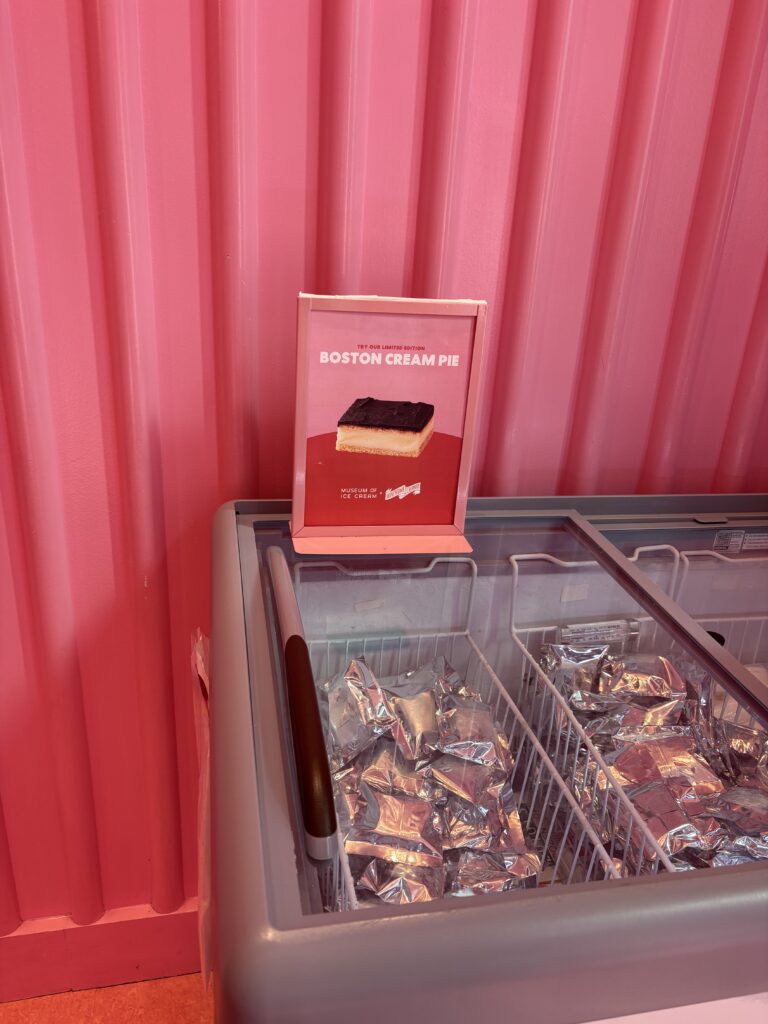 Boston Cream Pie sign on top of a freezer of ice cream