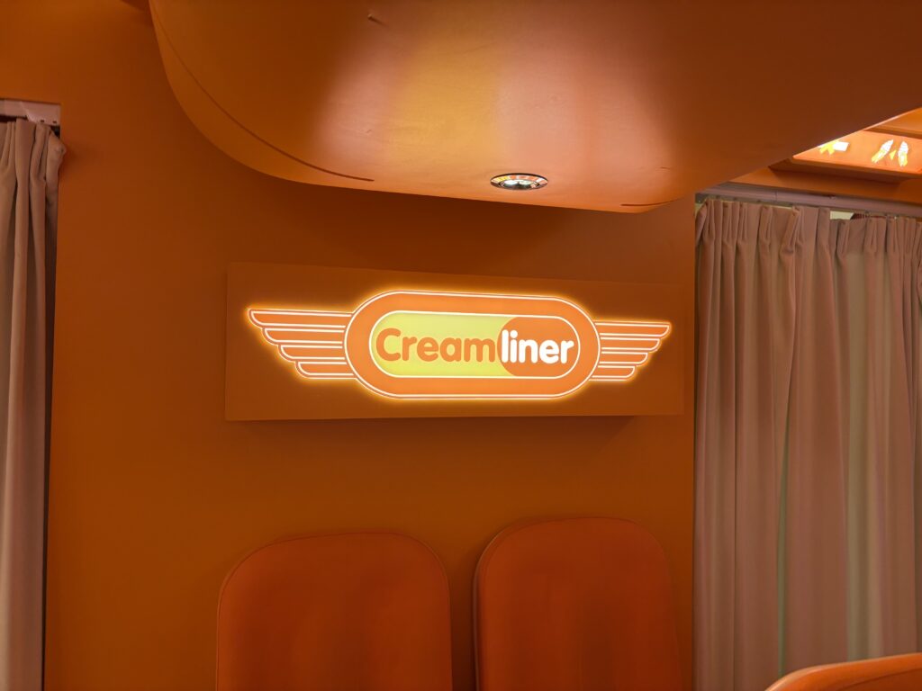 An illuminated orange sign that says Creamliner
